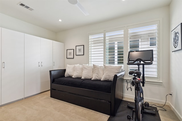 bedroom featuring ceiling fan, light colored carpet, and multiple windows