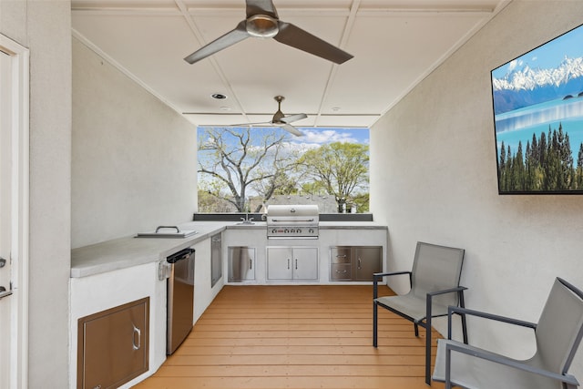 view of patio / terrace featuring ceiling fan, area for grilling, a wooden deck, and a grill