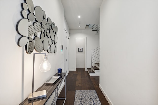 corridor with dark hardwood / wood-style flooring