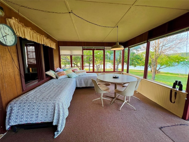 sunroom with a water view and a healthy amount of sunlight