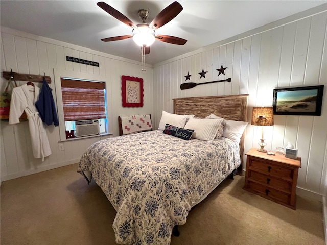 carpeted bedroom featuring wooden walls, ceiling fan, and cooling unit