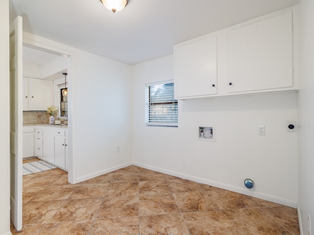 laundry room featuring hookup for a washing machine, cabinets, and electric dryer hookup