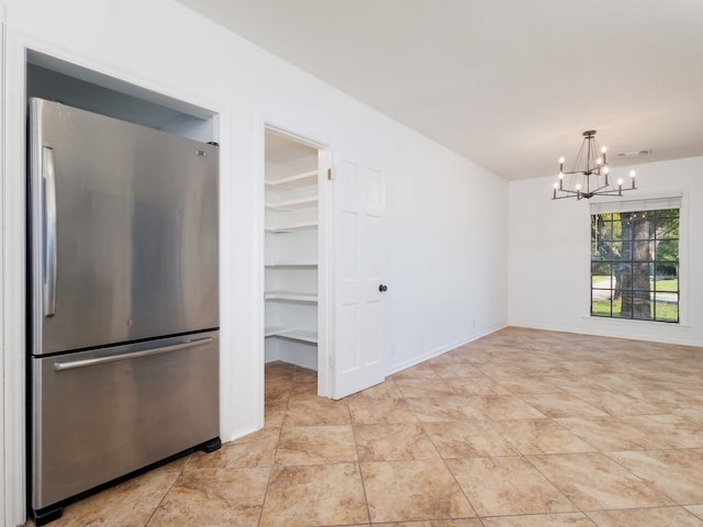 unfurnished dining area with a notable chandelier