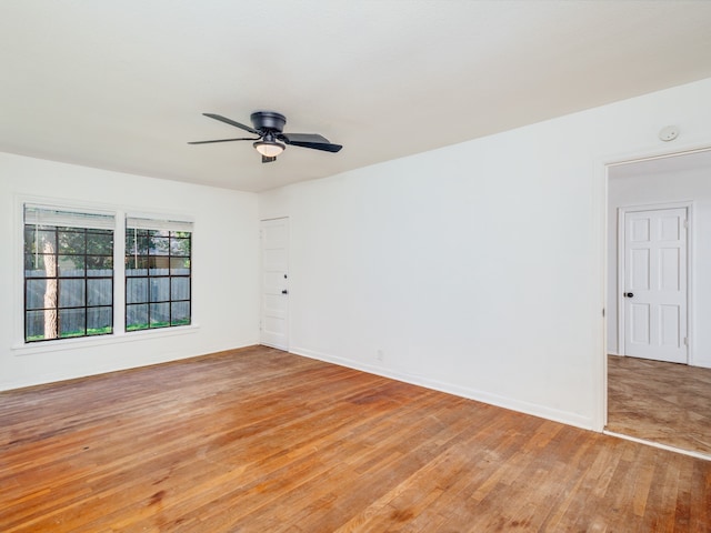 unfurnished room with light wood-type flooring and ceiling fan