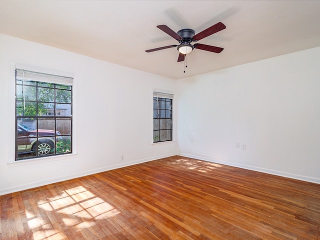 empty room with hardwood / wood-style flooring and ceiling fan