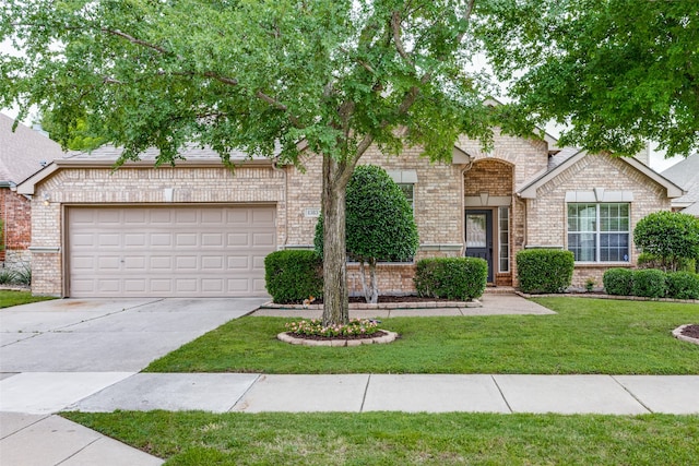 view of front of home with a front yard and a garage