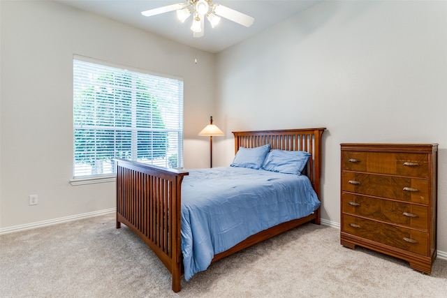 carpeted bedroom with multiple windows and ceiling fan