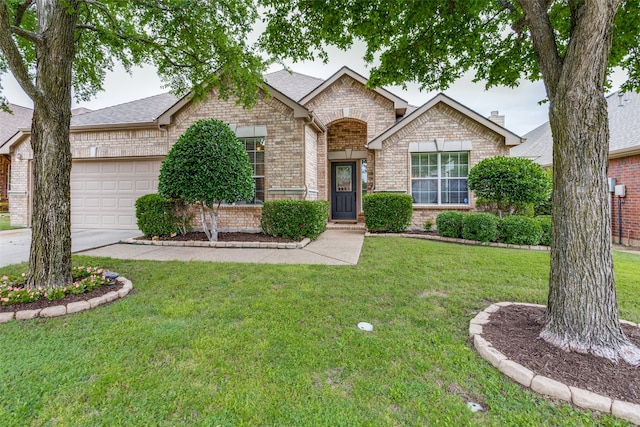 ranch-style house featuring a front lawn and a garage