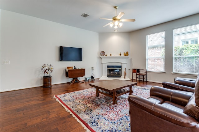 living room with ceiling fan and dark wood-type flooring