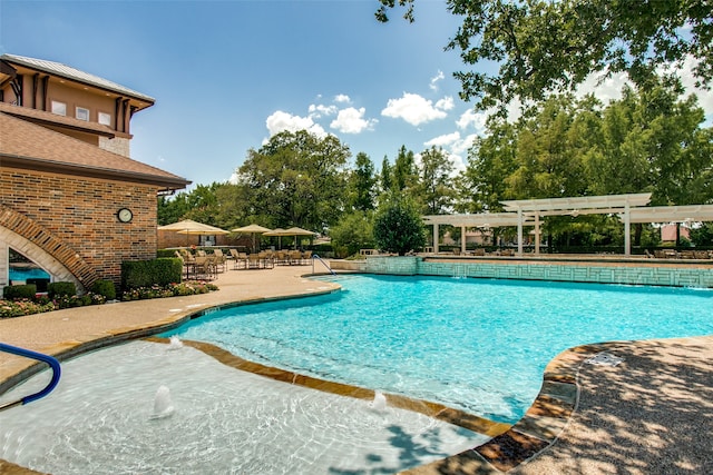 view of pool with a patio, a pergola, and pool water feature