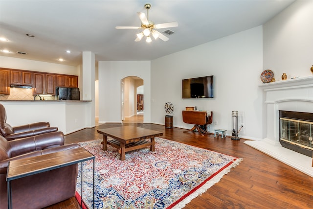 living room with dark wood-type flooring and ceiling fan