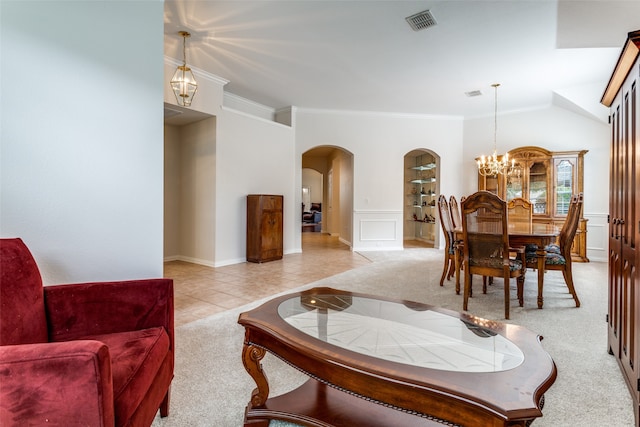 living room with a notable chandelier, light carpet, and crown molding