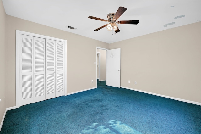 unfurnished bedroom with a closet, dark colored carpet, and ceiling fan