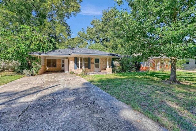 ranch-style house with a front yard and covered porch