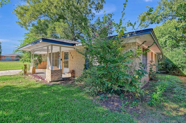 view of side of home with a yard