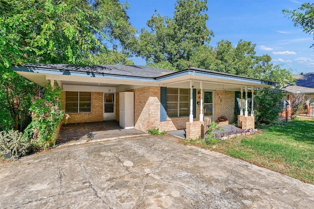 view of front facade with a carport and a front lawn