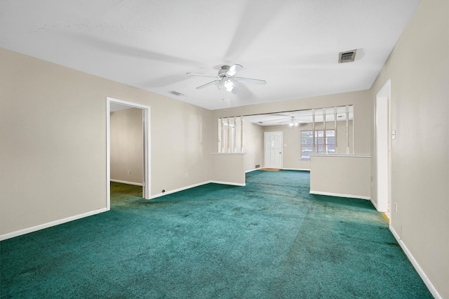 unfurnished living room featuring dark carpet and ceiling fan