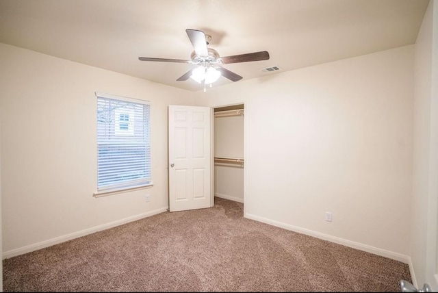 unfurnished bedroom with ceiling fan, a closet, and carpet