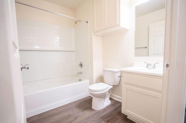 full bathroom with hardwood / wood-style flooring, tub / shower combination, vanity, and toilet