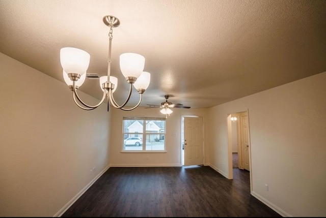 unfurnished room with ceiling fan with notable chandelier, dark wood-type flooring, and a textured ceiling