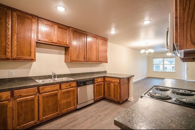 kitchen with pendant lighting, sink, stainless steel dishwasher, ceiling fan with notable chandelier, and light hardwood / wood-style floors