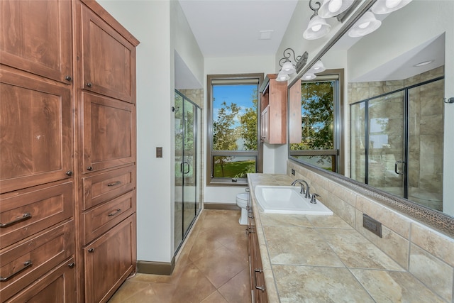 bathroom featuring walk in shower, vanity, toilet, and tile patterned floors