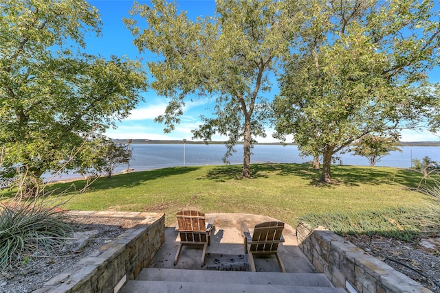 view of yard featuring a patio and a water view