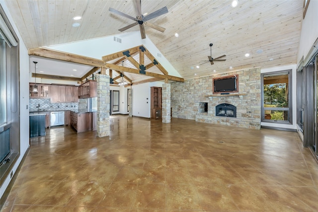 unfurnished living room featuring high vaulted ceiling, a stone fireplace, wooden ceiling, sink, and beam ceiling