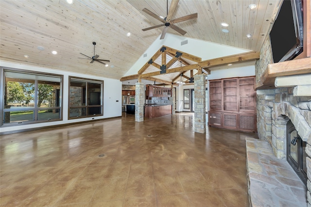 unfurnished living room featuring beamed ceiling, ornate columns, wooden ceiling, a fireplace, and high vaulted ceiling