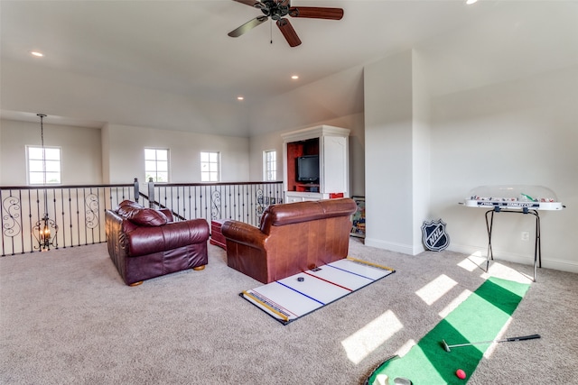 living room featuring light carpet, a towering ceiling, and ceiling fan