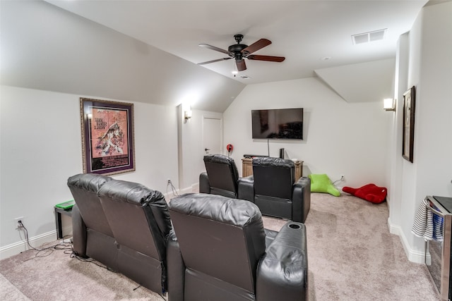 cinema room with light carpet, ceiling fan, and vaulted ceiling