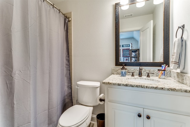 bathroom featuring vanity, a shower with curtain, and toilet