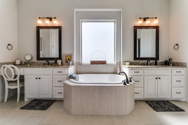 bathroom with vanity, a tub to relax in, and tile patterned floors