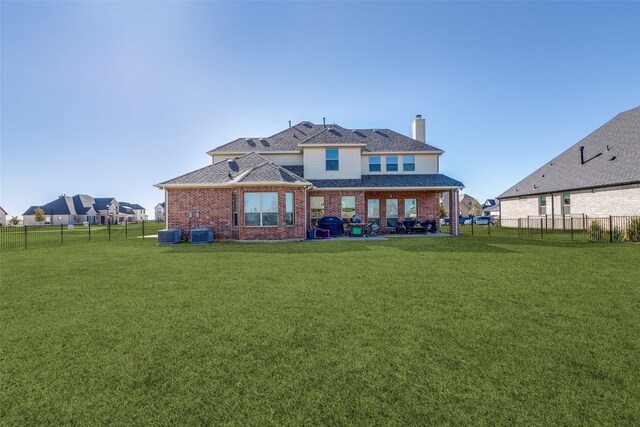 rear view of house featuring a yard and a patio area