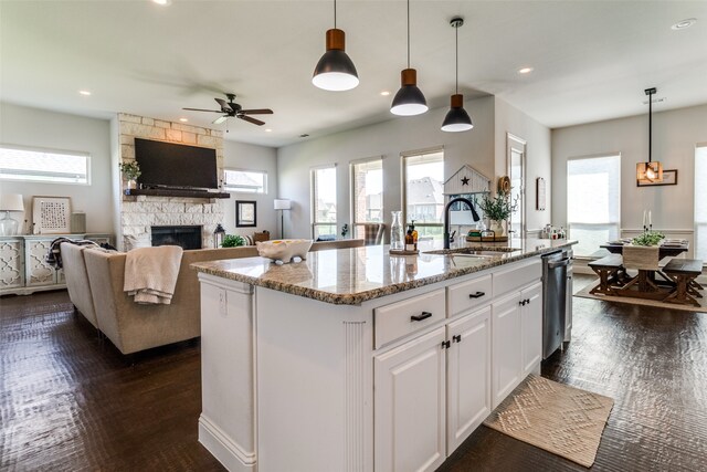 kitchen with white cabinets, a healthy amount of sunlight, sink, and a kitchen island with sink