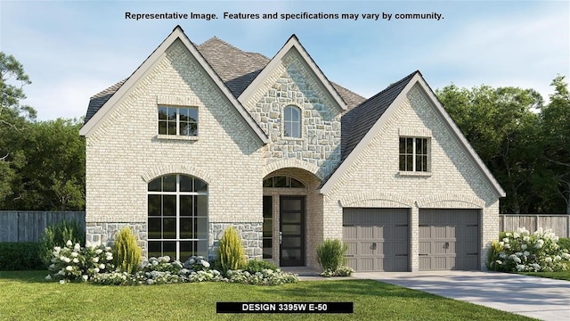 view of front of home with a front lawn and a garage