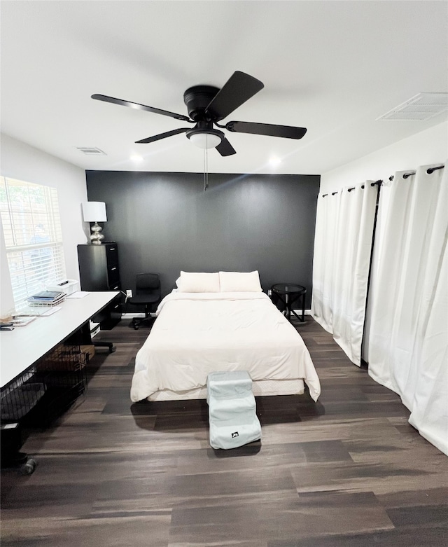 bedroom featuring ceiling fan and dark hardwood / wood-style flooring