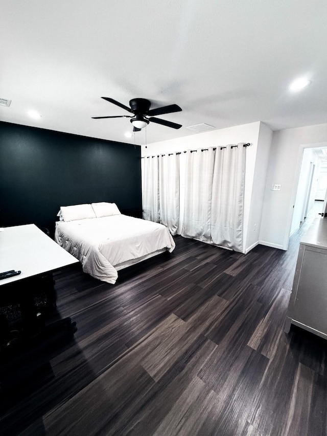 bedroom featuring dark hardwood / wood-style flooring and ceiling fan