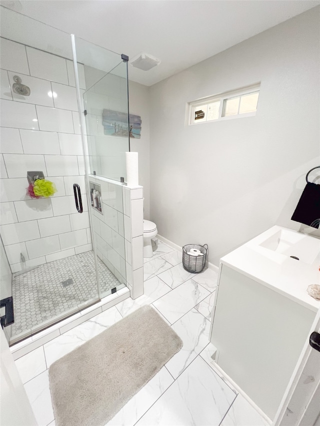 bathroom featuring vanity, toilet, and an enclosed shower