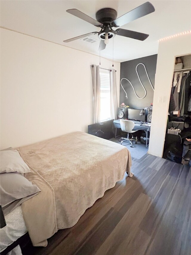 bedroom featuring ceiling fan, a closet, and hardwood / wood-style floors