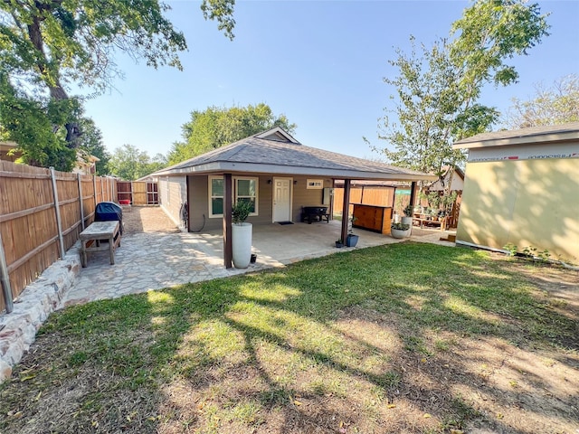 back of property featuring a patio area and a lawn