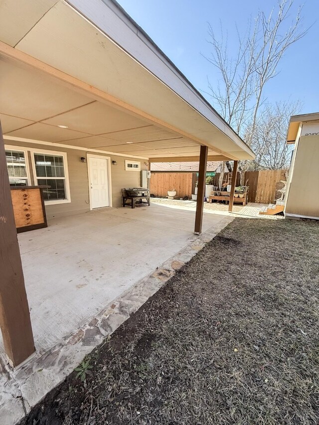 view of yard featuring a patio and a storage unit