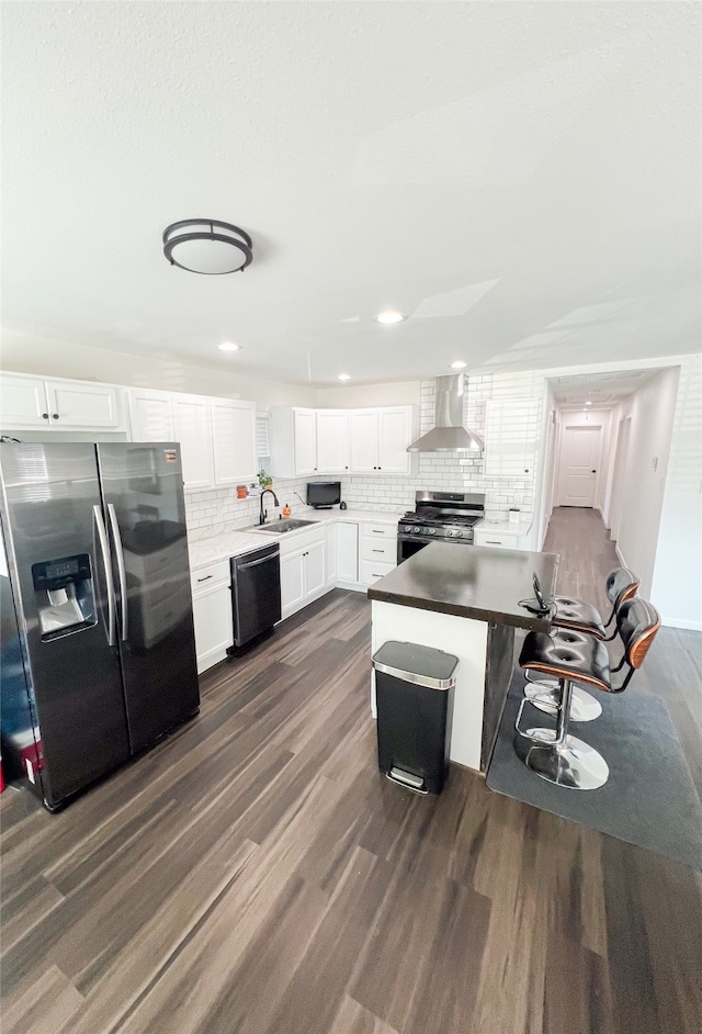 kitchen with black appliances, white cabinetry, wall chimney exhaust hood, and dark hardwood / wood-style flooring