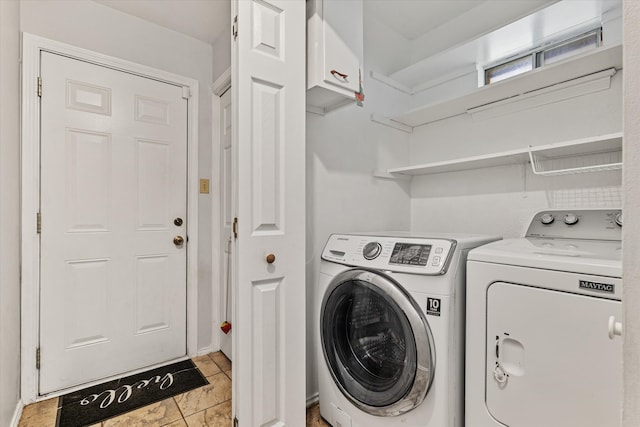 washroom featuring light tile patterned floors and washer and dryer