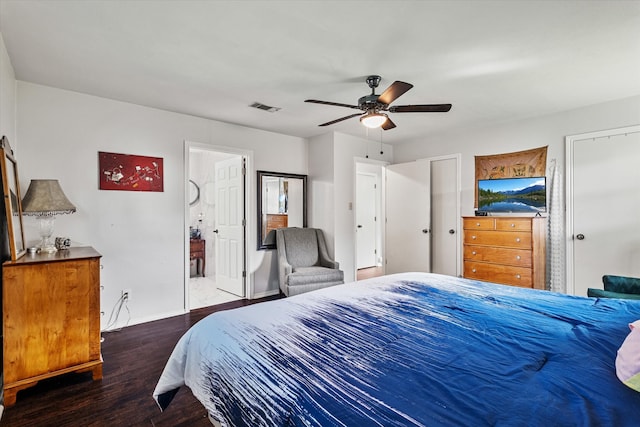 bedroom featuring ceiling fan, ensuite bath, and dark hardwood / wood-style floors