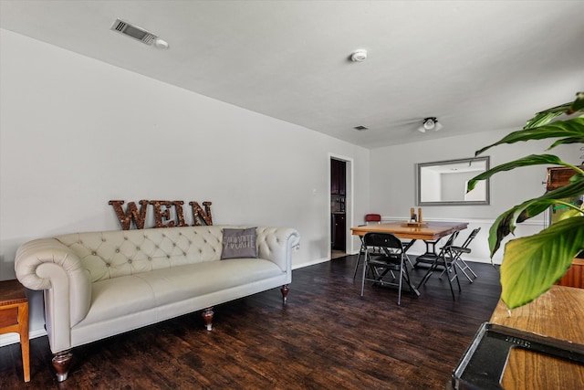 living room with dark hardwood / wood-style flooring