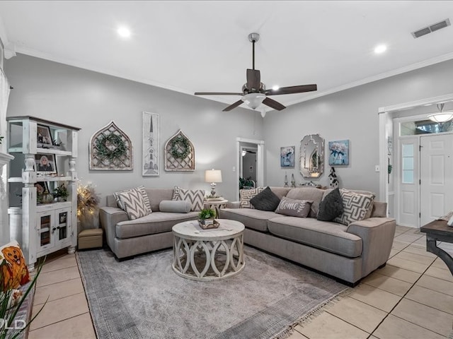 living room featuring light tile patterned flooring, ornamental molding, and ceiling fan