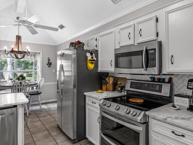 kitchen with white cabinets, appliances with stainless steel finishes, lofted ceiling with beams, and tasteful backsplash