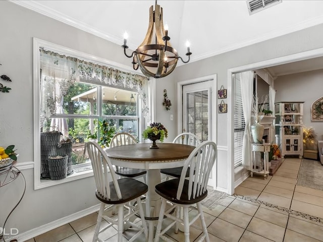 tiled dining room with ornamental molding and a chandelier