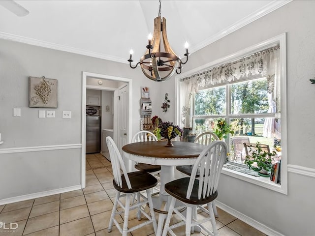 tiled dining room with crown molding, vaulted ceiling, and an inviting chandelier